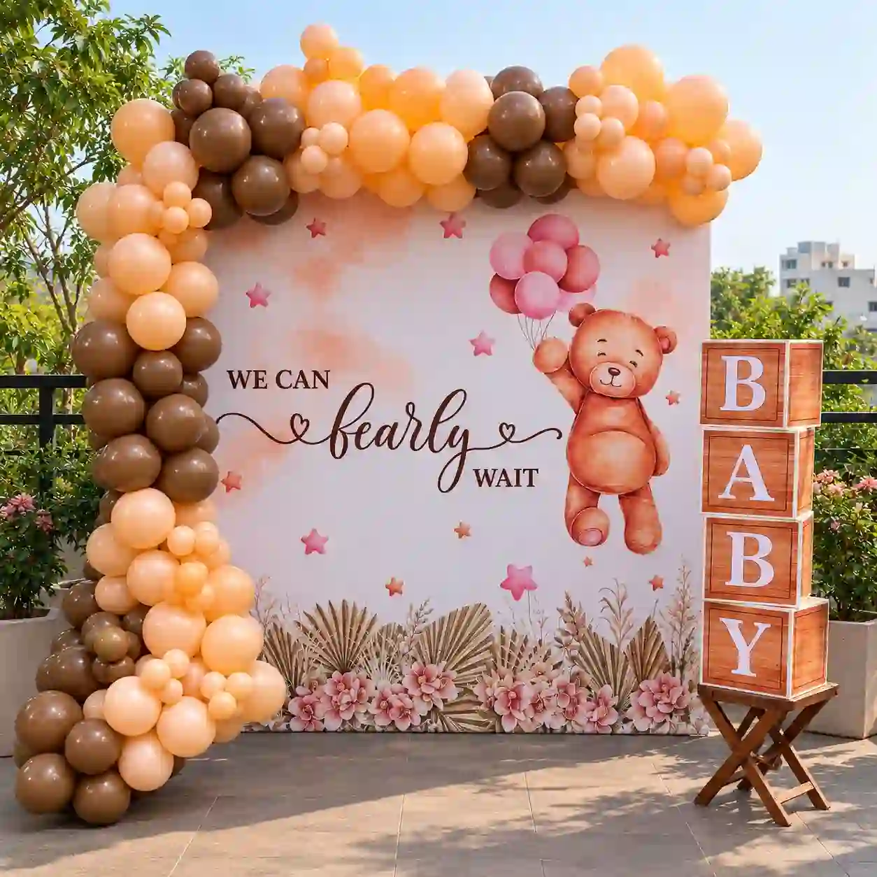 Bearly Waiting baby shower decoration with teddy bear backdrop, apricot, chocolate brown and beige balloon arch, and BABY boxes