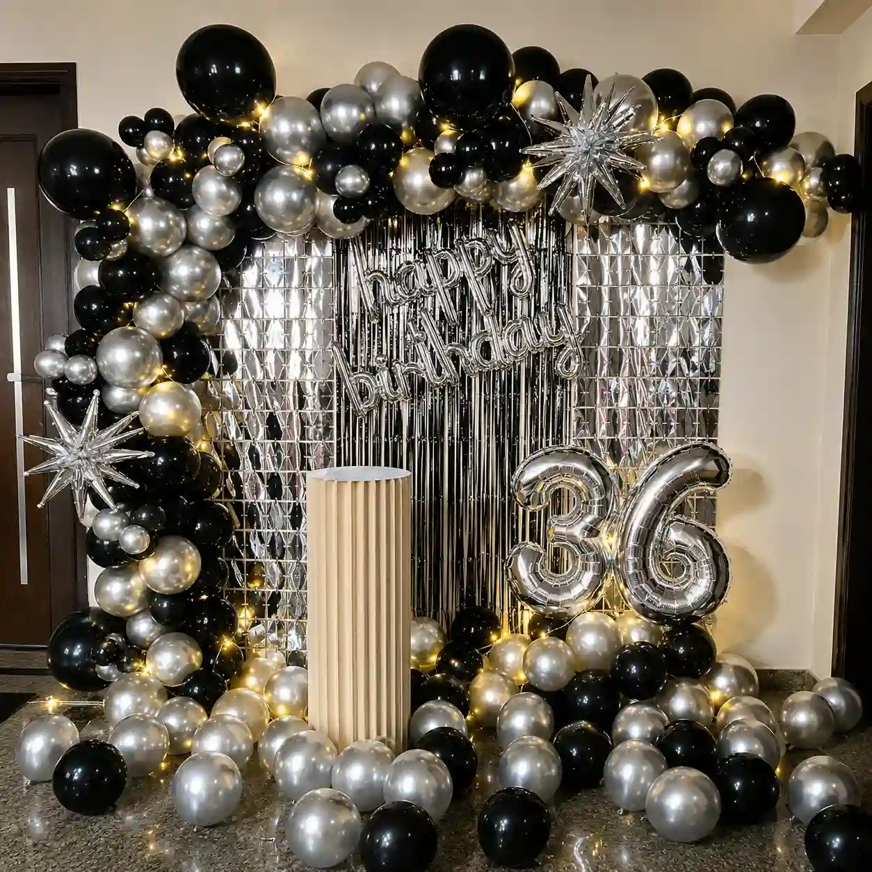 Metallic and silver birthday balloon decoration with balloon arch and birthday backdrop