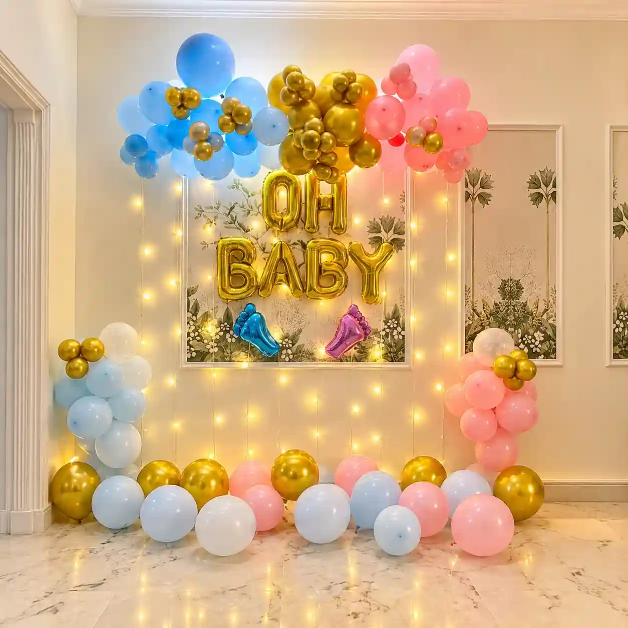 Oh Baby gender reveal decoration with blue, pink and gold balloon arch, golden OH BABY balloons and baby foot balloons